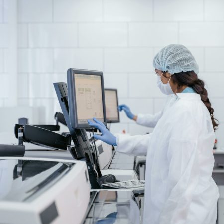Female scientist in protective gear using lab equipment for research.. Photo by ima Miroshnichenko via Pexels (CC0)