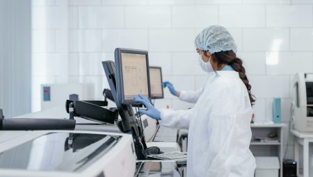 Female scientist in protective gear using lab equipment for research.. Photo by ima Miroshnichenko via Pexels (CC0)
